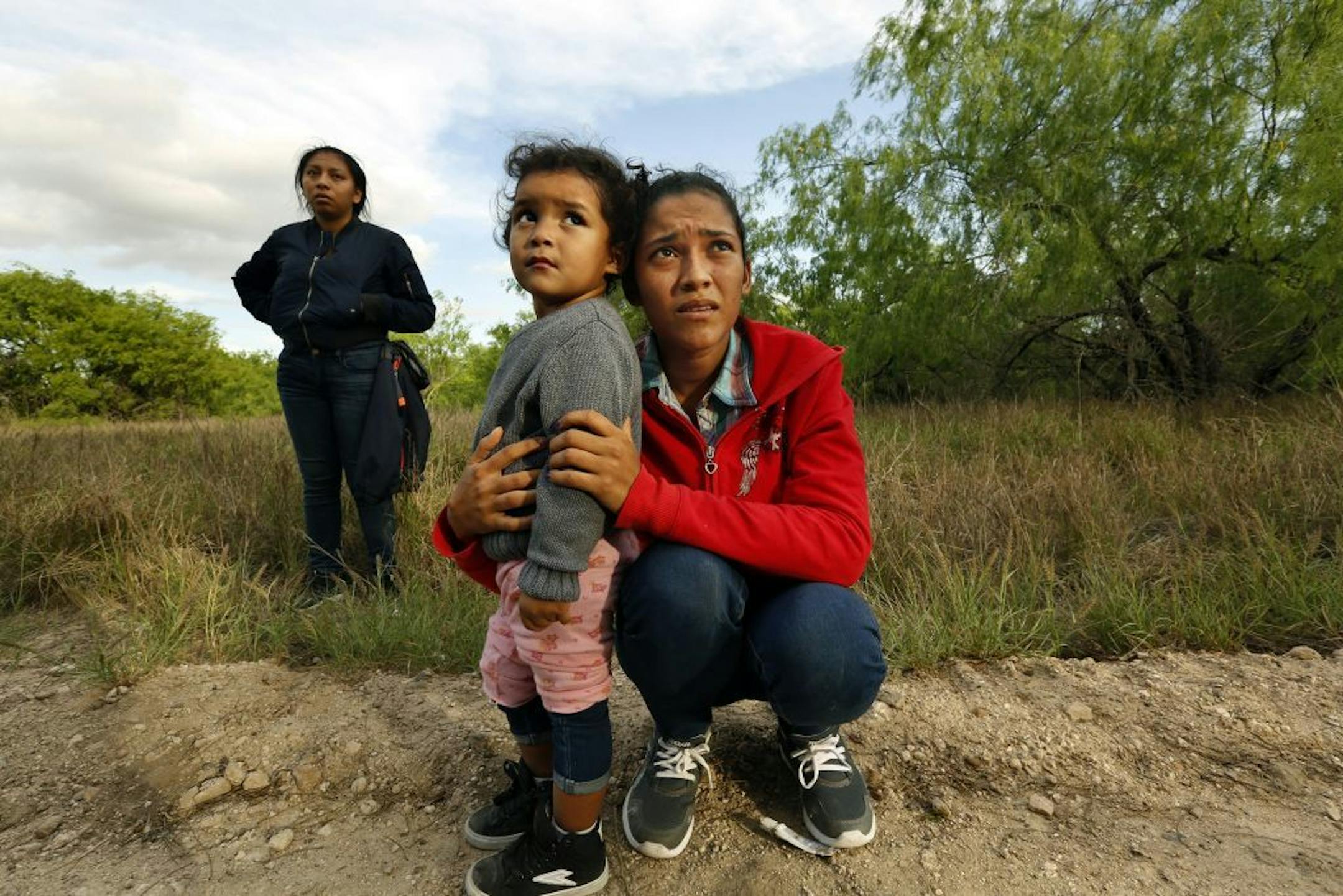 Lirio Funes, 20, holds onto her daughter Melissa Funes, 2, just after being detained by local officials after crossing the U.S. - Mexico border on March 15, 2018 in McAllen, Texas.