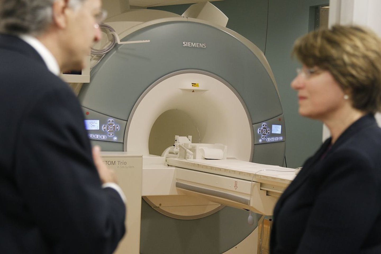 Dr. Kamil Ugurbil, left, gave Senator Amy Klobuchar, center, a tour of the Center for Magnetic Resonance Research Center at the U of M, Tuesday, April 30, 2013 in Minneapolis, MN. (ELIZABETH FLORES/STAR TRIBUNE) ELIZABETH FLORES � eflores@startribune.com