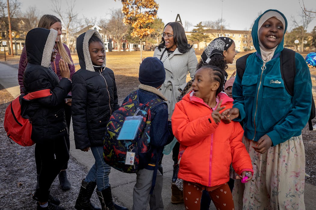 New superintendent of Minneapolis Public Schools, Lisa Sayles-Adams, center, greeted students as they get off the bus at Whittier Elementary School during her first day on the job.