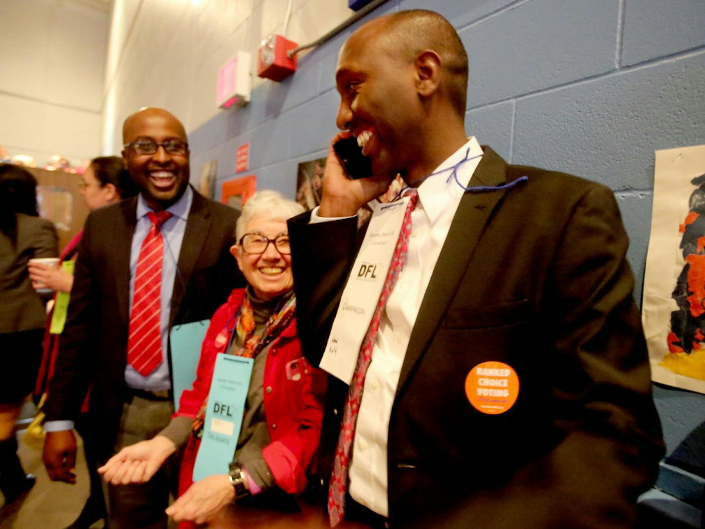 Mohamud Noor, a challenger to DFL Rep. Phyllis Kahn, takes a phone call as Kahn looks on at Northeast Middle School during the DFL endorsing convention Saturday, April 9, 2016, in Minneapolis.