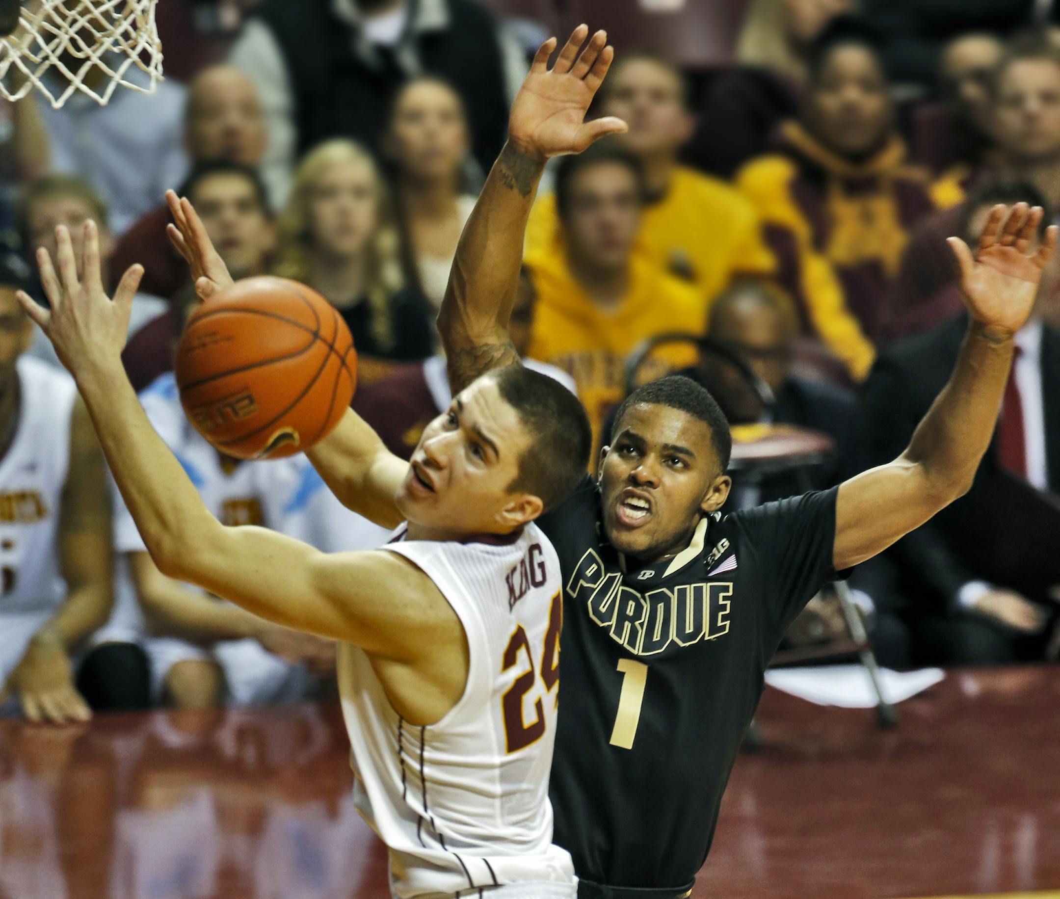 Minnesota's Joey King, left, and Purdue's Sterling Carter (1) fought for control of a lose ball in 2nd half action.
