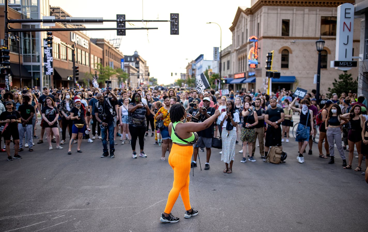 A woman spoke to the crowd at the intersections of S. Girard Ave and W. Lake St. in the Uptown neighborhood of Minneapolis.