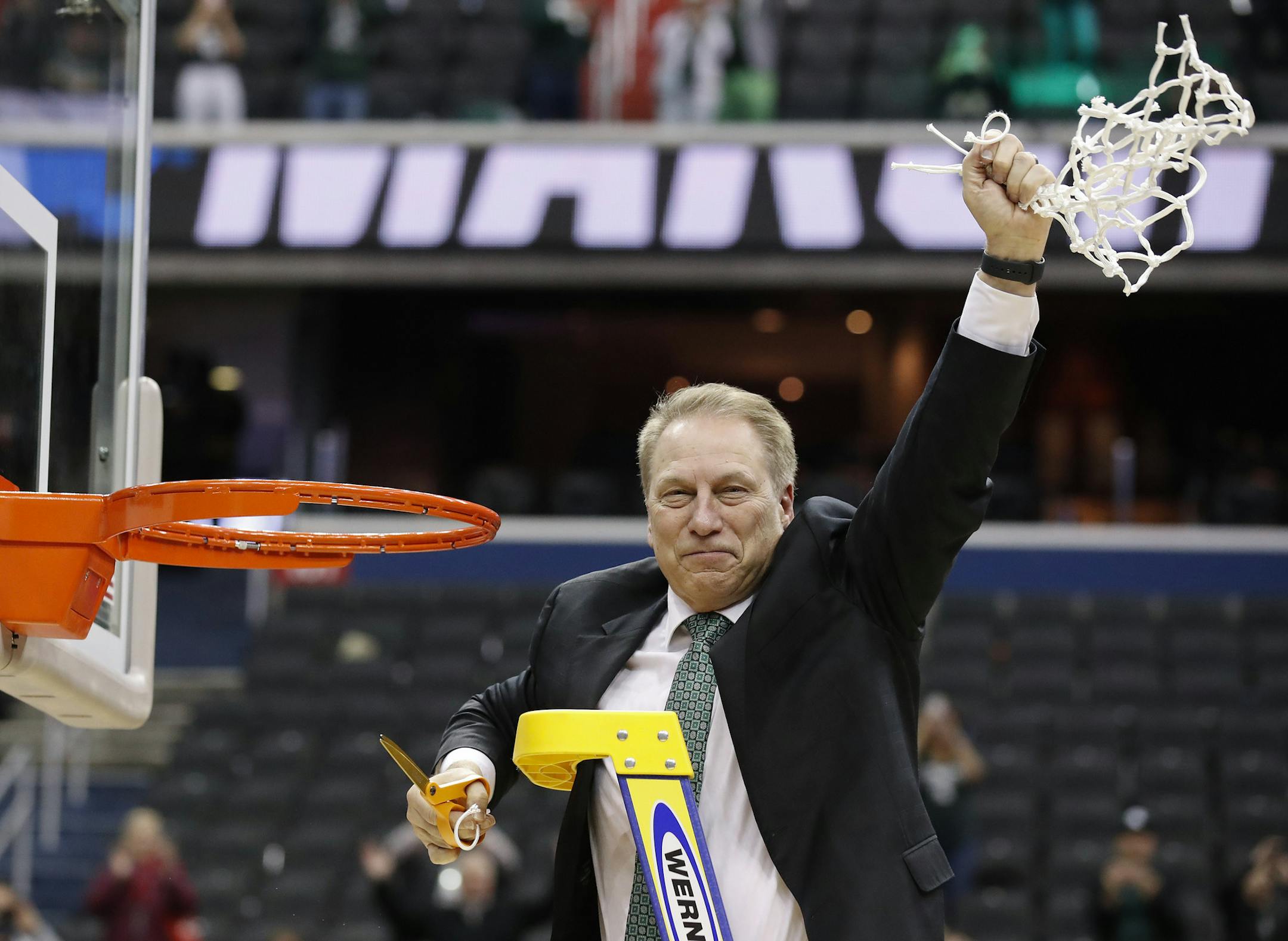 Michigan State head coach Tom Izzo holds up the net after defeating Duke in an NCAA men's East Regional final college basketball game in Washington, Sunday, March 31, 2019. Michigan State won 68-67. (AP Photo/Alex Brandon)