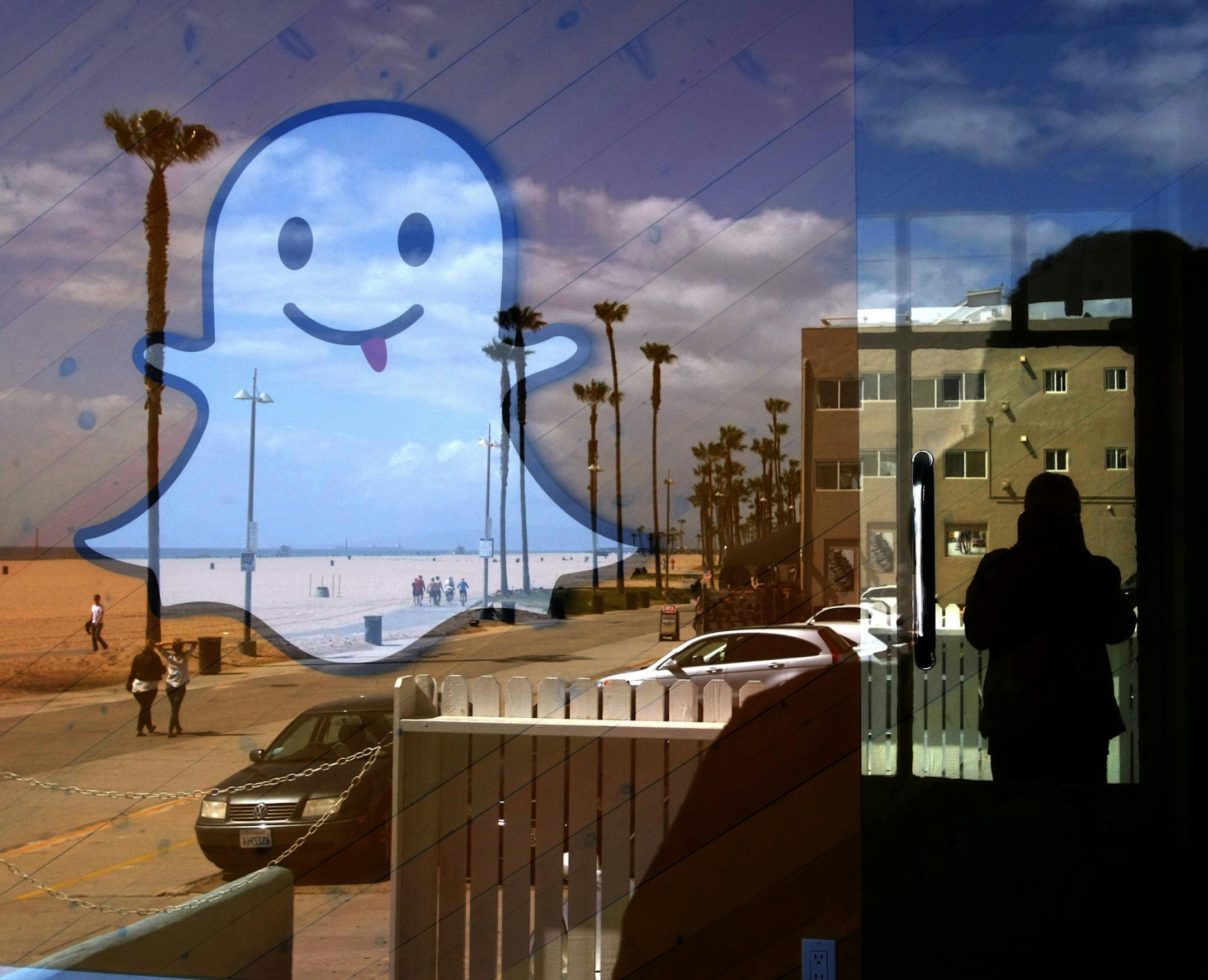 The Snapchat logo seems to float over Ocean Front Walk in Los Angeles' Venice neighborhood in 2013. (Genaro Molina/Los Angeles Times/TNS) ORG XMIT: 1198068