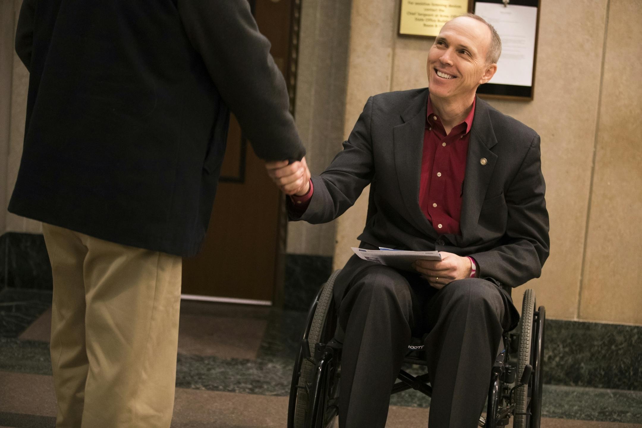 Rep. Rod Hamilton talks in the hallway of the State Office Building.