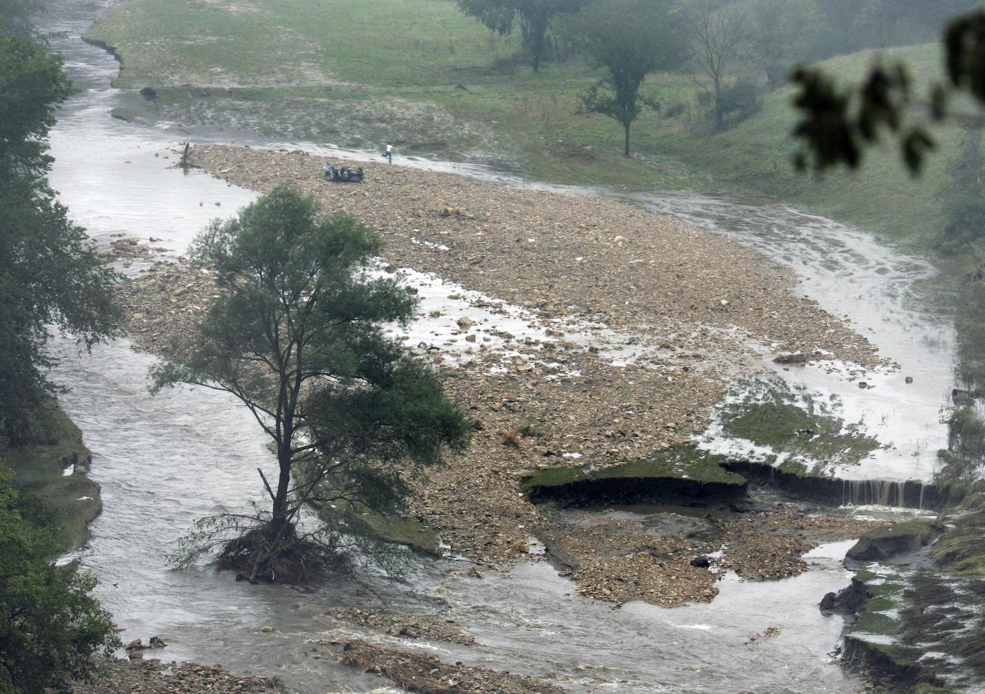 BRIAN PETERSON &#x2022; Brianp@startribune.com
Rushford, MN - 8/19/2007
A car found in Rush Creek (top left) south of I-90 west of Wilson is believed to have been occupied, a Hwy patrol officer near the scene said they have a missing person related to the car and were planning to search the river. This view shows the emence power of the flash flood that carried the car to it's present position. Athorities were preparing to search for a missing person at the site.