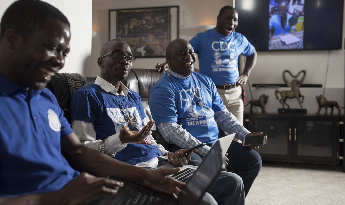 Alexander Toteh, left, Amos Togbeson, Jr, Alexander G Walker and Charles Krogee chairman of the Coalition for Democratic Change MN listened to live reports from Monrovia Liberia, during a landmark presidential run-off election that is underway in Liberia Tuesday December 26, 2017 in Brooklyn Park, MN.] JERRY HOLT &#xef; jerry.holt@startribune.com