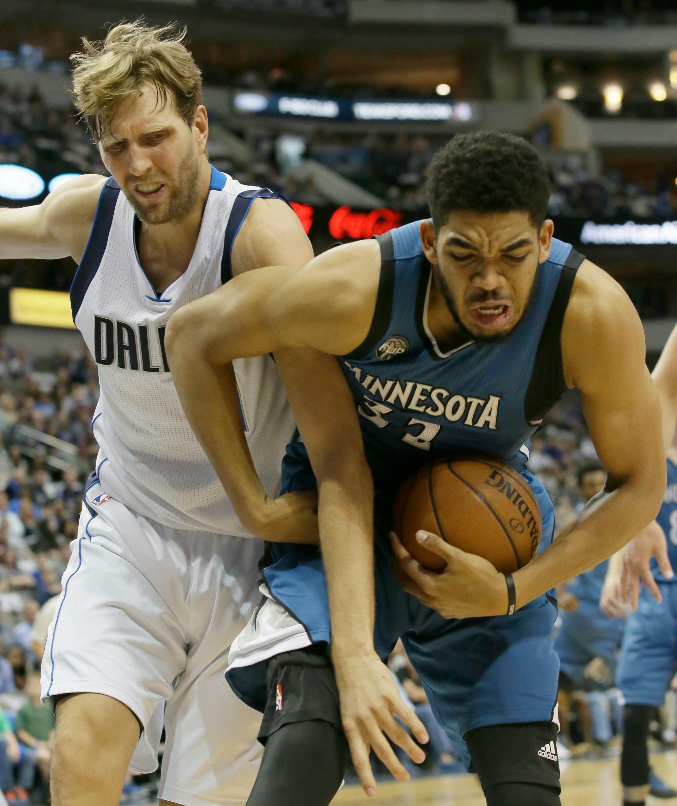 Minnesota Timberwolves center Karl-Anthony Towns (32) and Dallas Mavericks forward Dirk Nowitzki (41) battle for control of the ball during the first half of an NBA basketball game Sunday, Feb. 28, 2016, in Dallas. (AP Photo/LM Otero)