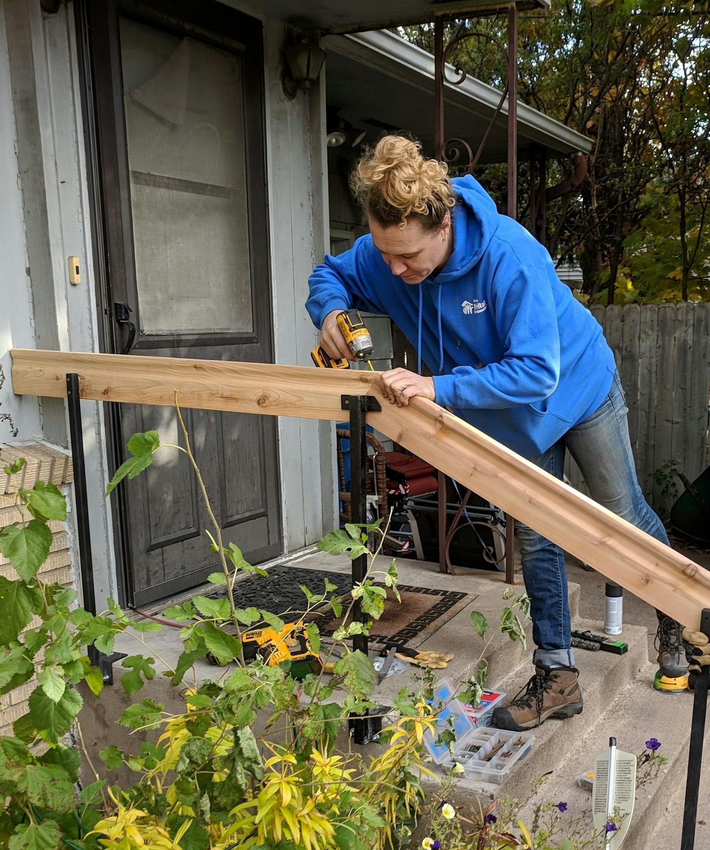 Project supervisor Ashley Realbanas installed a railing at a home.