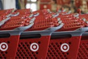 FILE- In this Thursday, July 5, 2012, file photo, rows of carts await customers at a Target store in Chicago. Discount retailer Target Corp. said Thur
