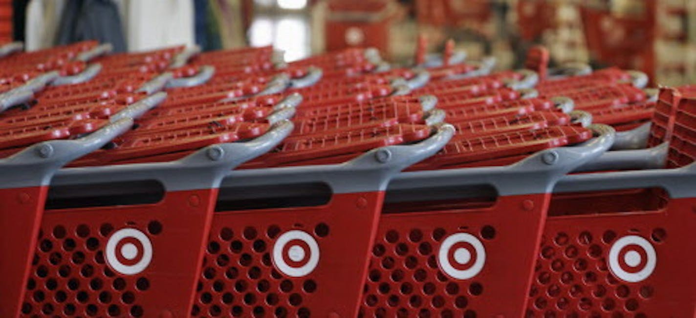 FILE- In this Thursday, July 5, 2012, file photo, rows of carts await customers at a Target store in Chicago. Discount retailer Target Corp. said Thursday, Aug. 2, 2012 that a key revenue measure rose more than expected in July, as more shoppers visited its stores and spent more on their purchases. (AP Photo/M. Spencer Green, File) ORG XMIT: MIN2012081516160828