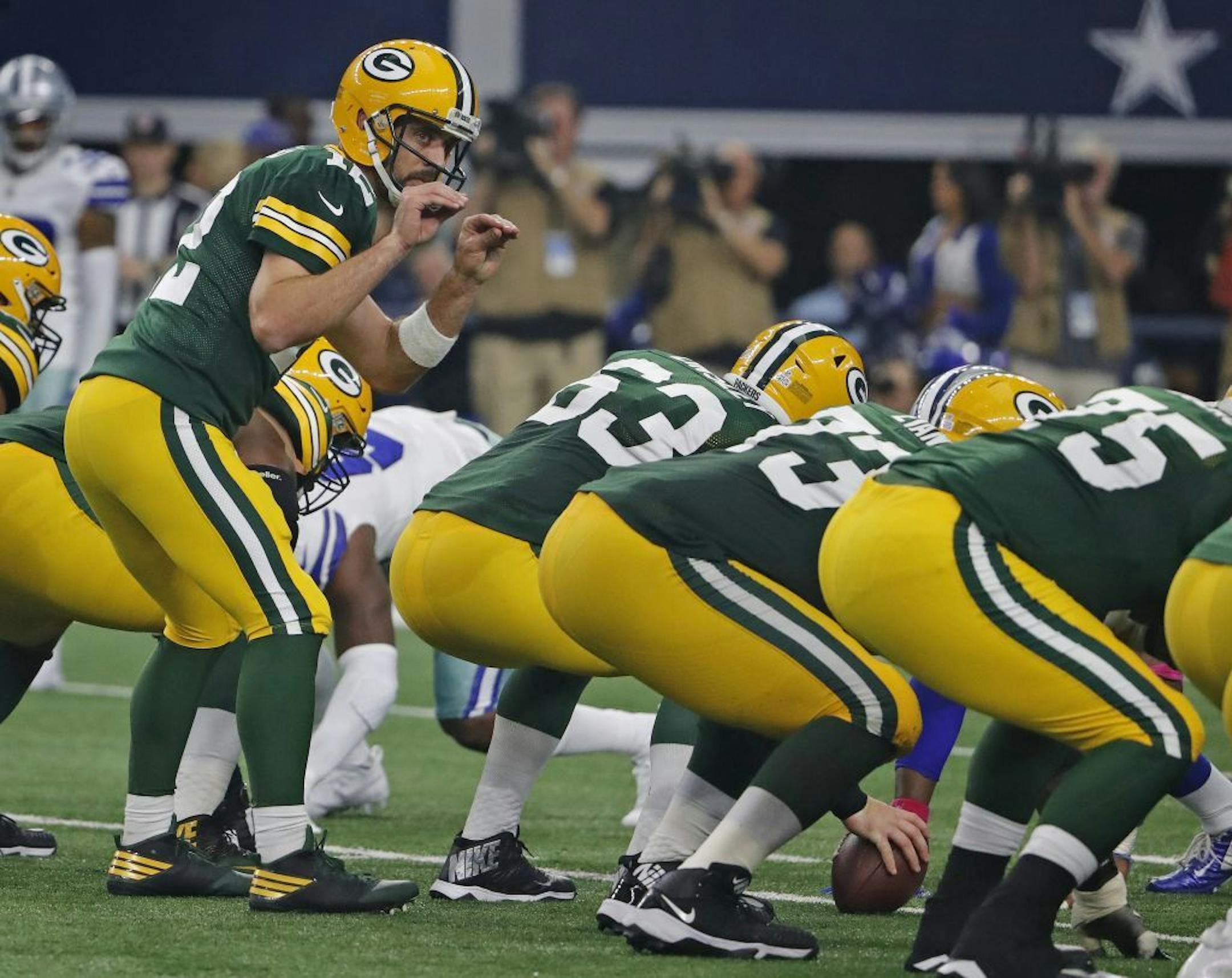 Green Bay Packers quarterback Aaron Rodgers (12) signals to his linemen in the fourth quarter against the Dallas Cowboys at AT&T Stadium in Arlington, Texas, on Sunday, Oct. 8, 2017.