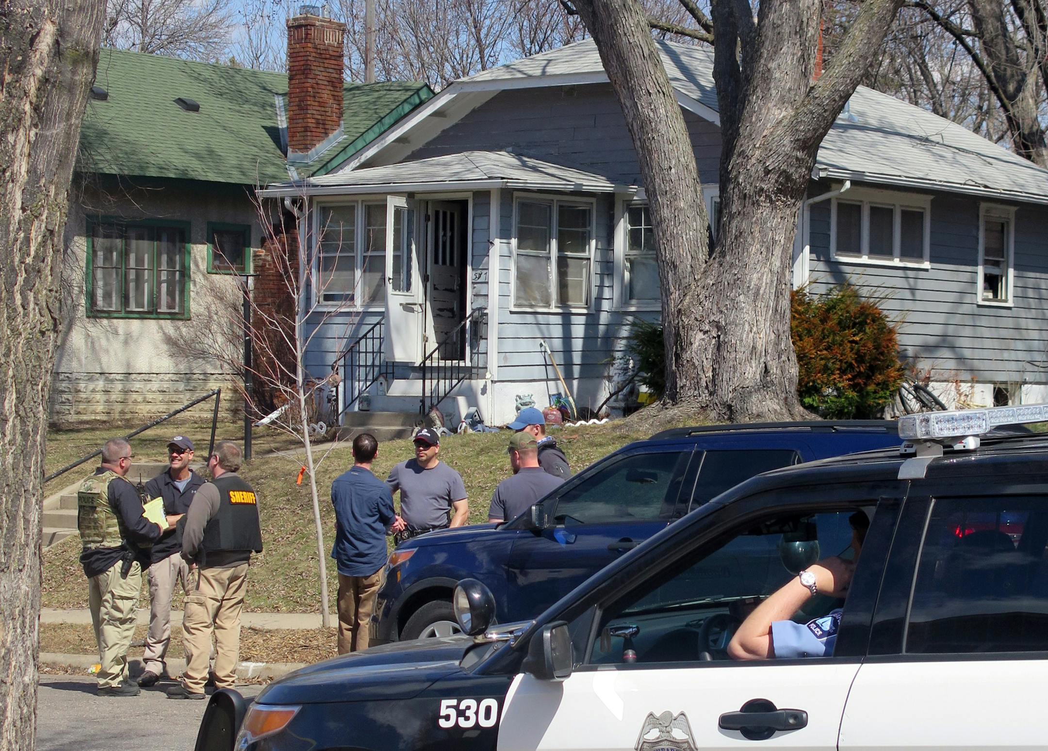 Police gather outside a house at 5137 Abbott Av S. in Minneapolis on Friday afternoon. A raid on the Fulton neighborhood house led to the discovery of a functioning meth lab tucked into the basement,