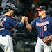 Minnesota Twins relief pitcher Matt Belisle (9) and catcher Jason Castro (21) fist-bump after the Twins defeated the Chicago White Sox 4-1 in a baseba