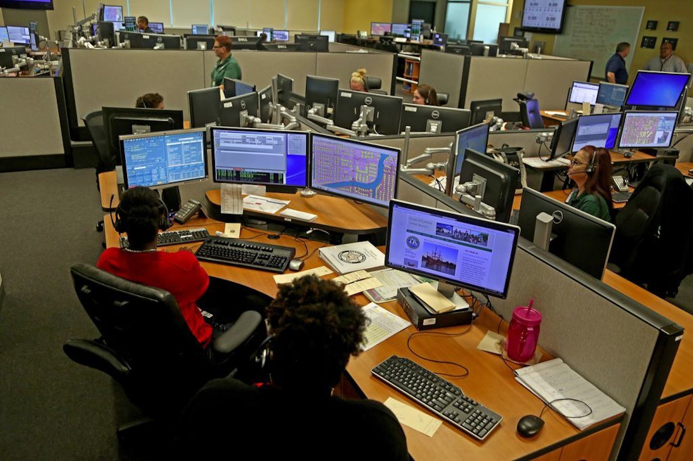 Operators answer emergency calls at a Broward County 911 dispatch center in July 2015.