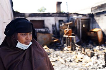 Kaltuma Hassan, owner of Bismillah Grocery & Coffee shop, is shown in a photo taken a few weeks after the establishment was burned in the riots on Lak