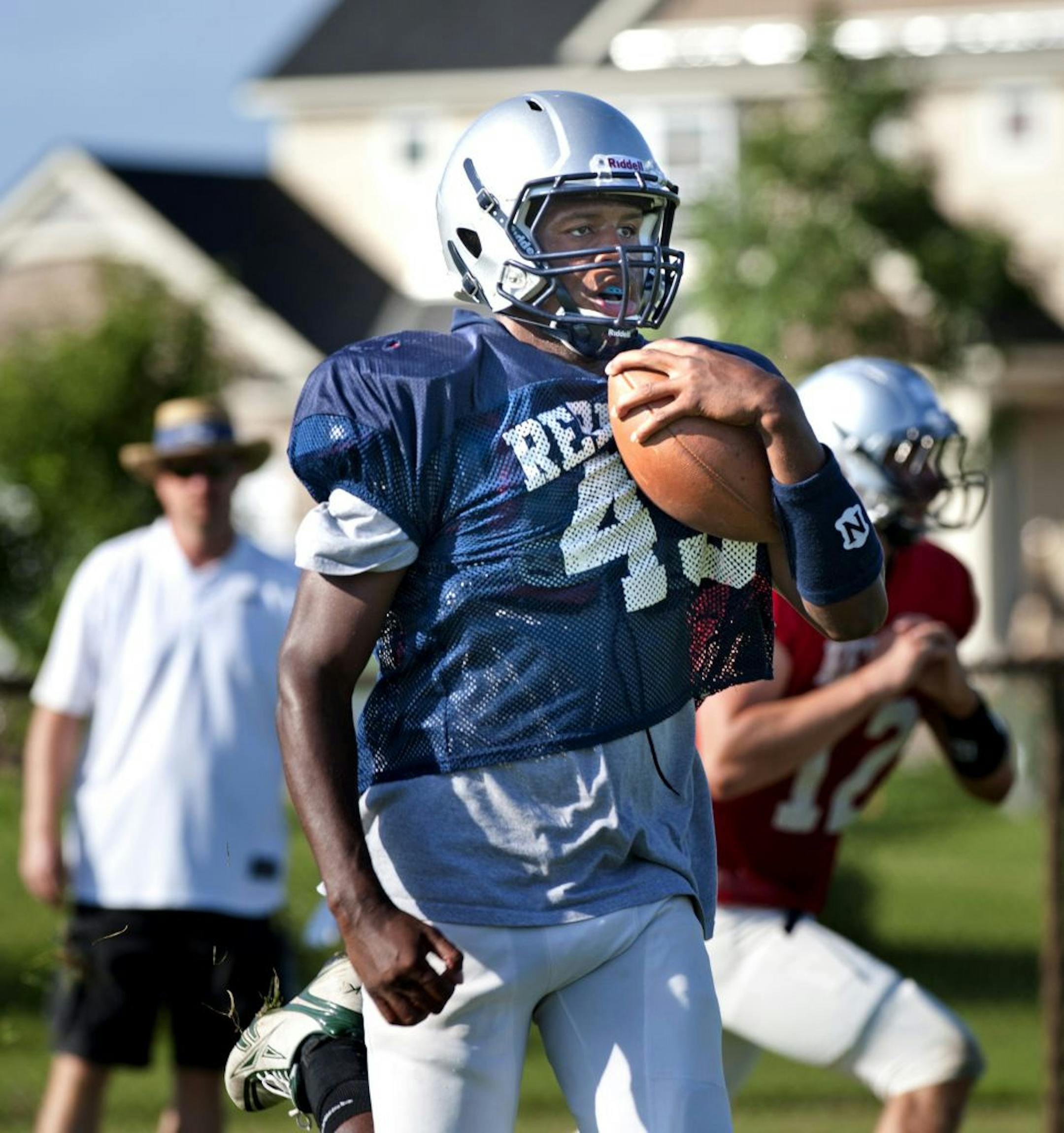 Champlin Park High School football running back Michael Sales wearing practice jersey #45 ran drills during an early morning practice. Thursday August 18, 2011.