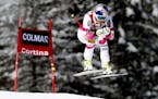 Lindsey Vonn takes a jump on her way to win an alpine ski, women's World Cup downhill in Cortina d'Ampezzo, Italy, Sunday, Jan. 18, 2015.