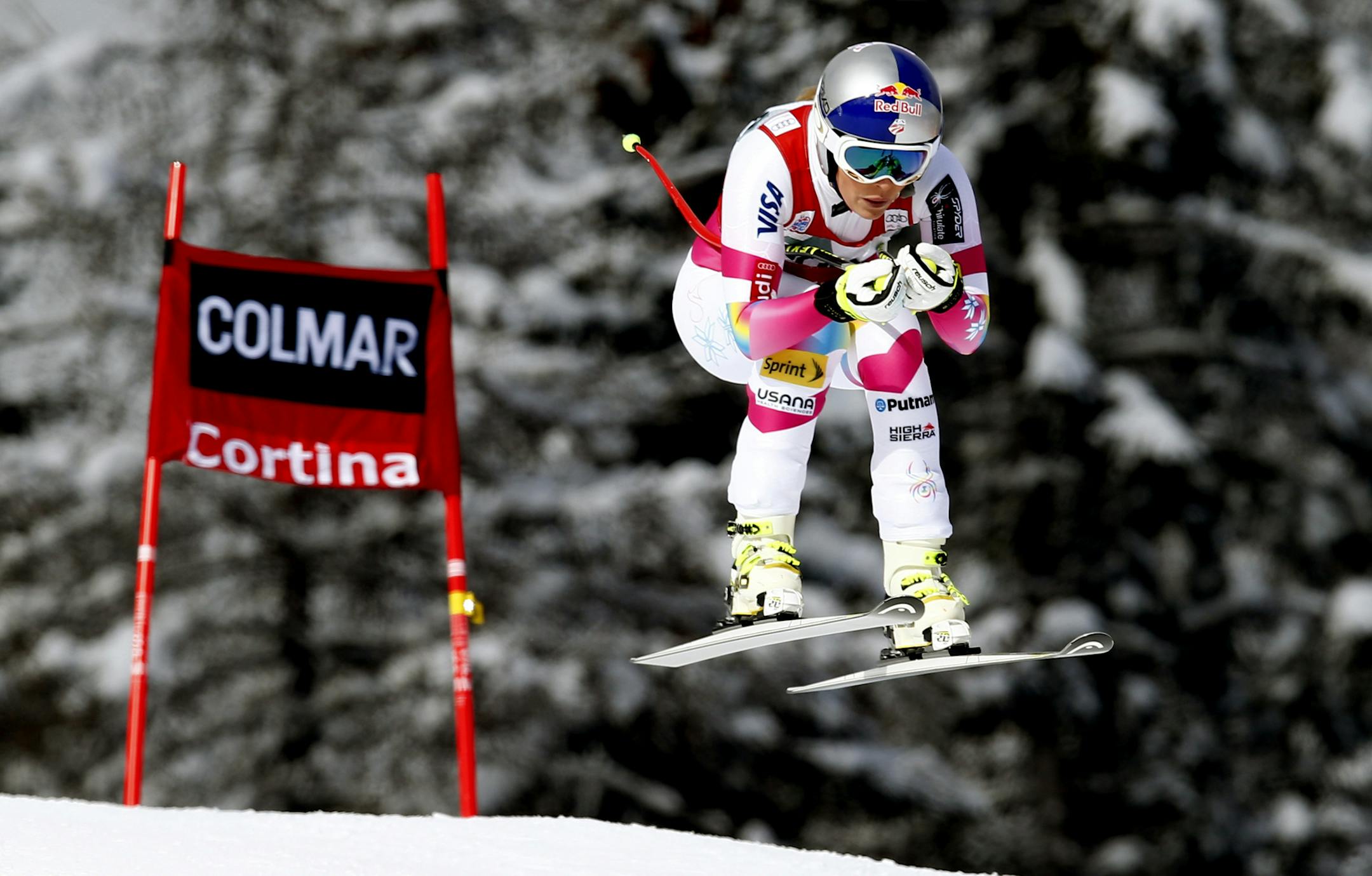 Lindsey Vonn takes a jump on her way to win an alpine ski, women's World Cup downhill in Cortina d'Ampezzo, Italy, Sunday, Jan. 18, 2015.