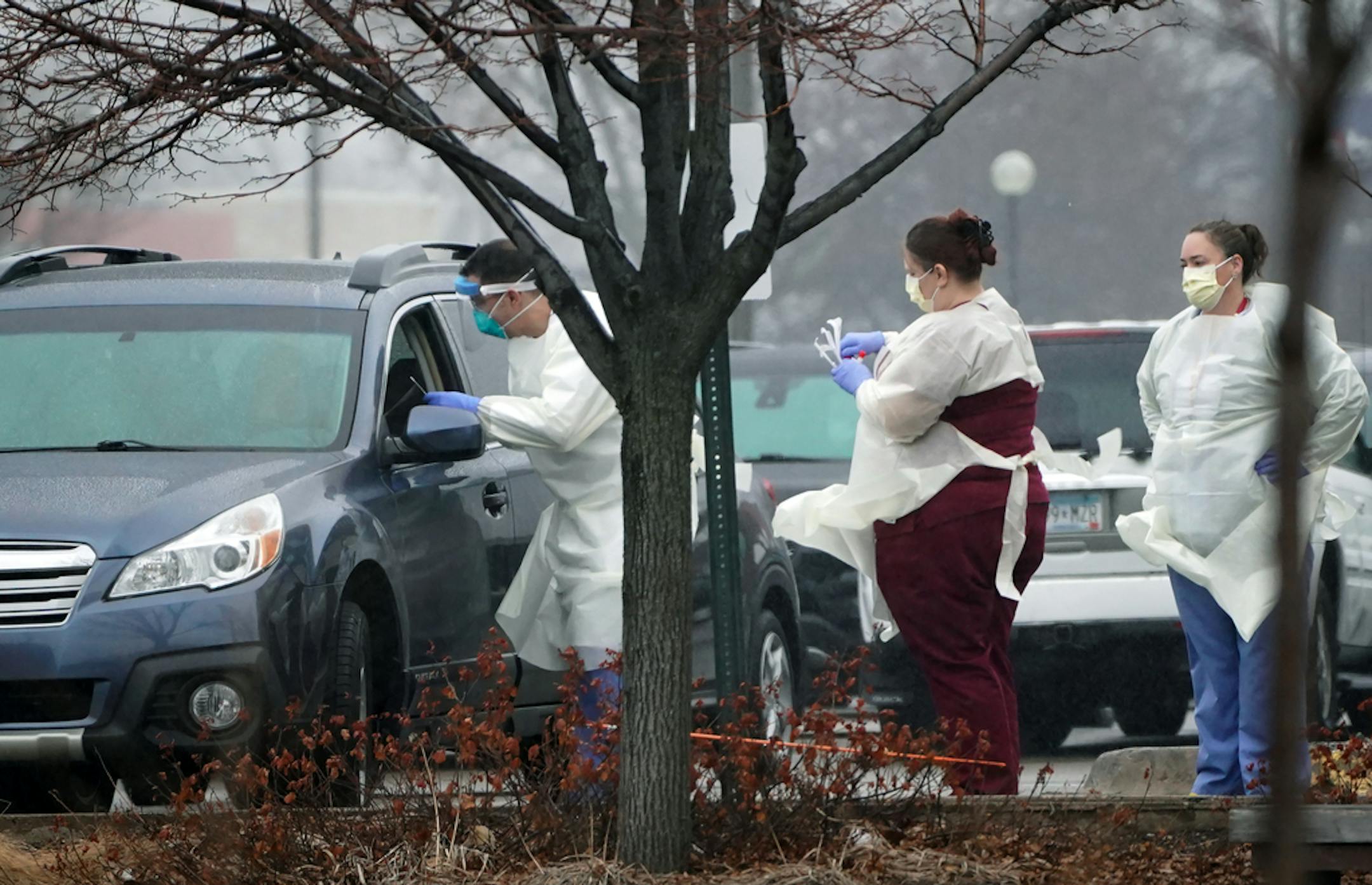 Medical staff at a Fairview clinic exited the building in safety gear and appeared to administer a test for COVID-19 to a patient parked in a car in the clinic parking lot on Thursday, March 12, 2020.