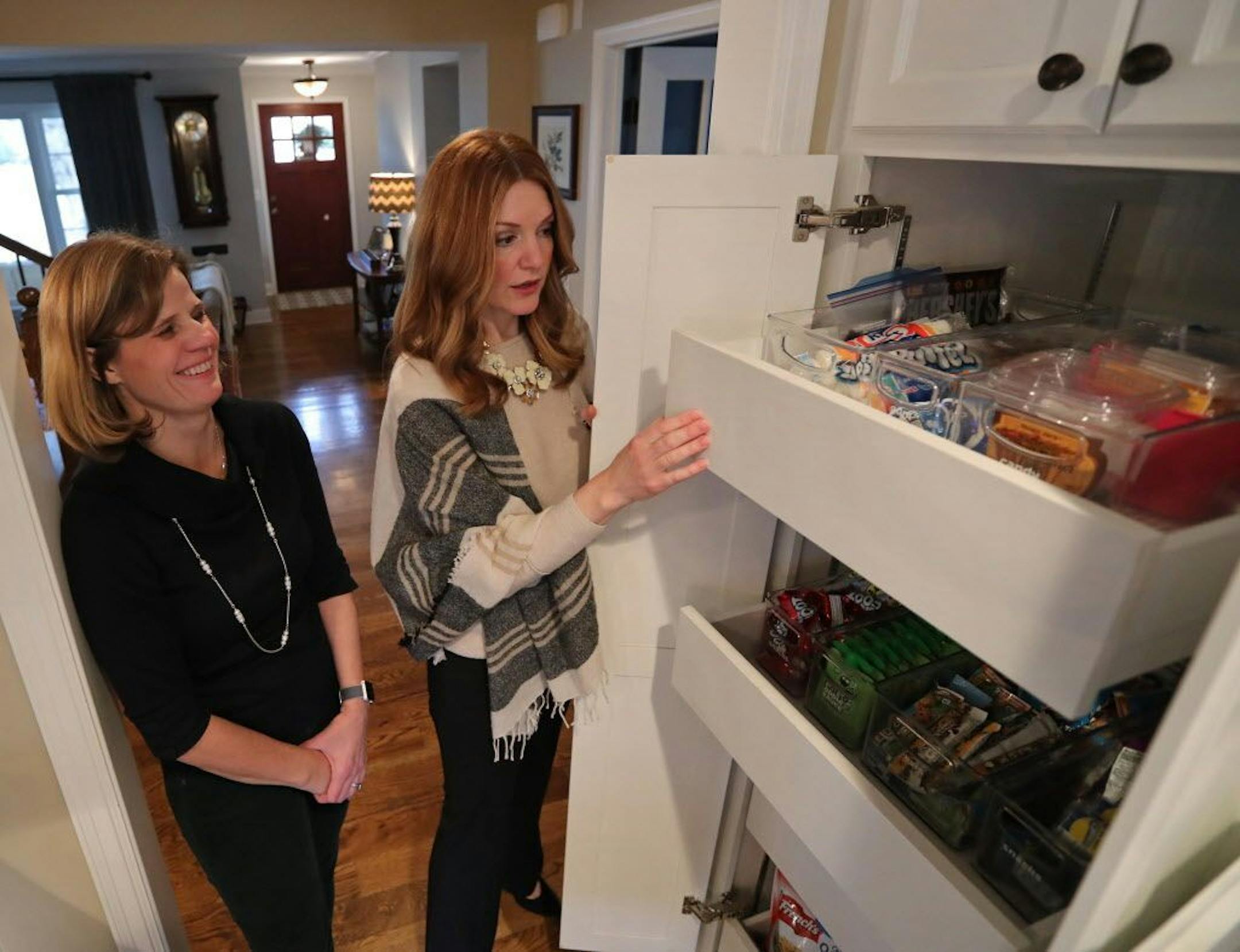 Kershner and Vig display the reorganized snack drawer, designed to help Kershner's three children easily grab what they want for their lunches.