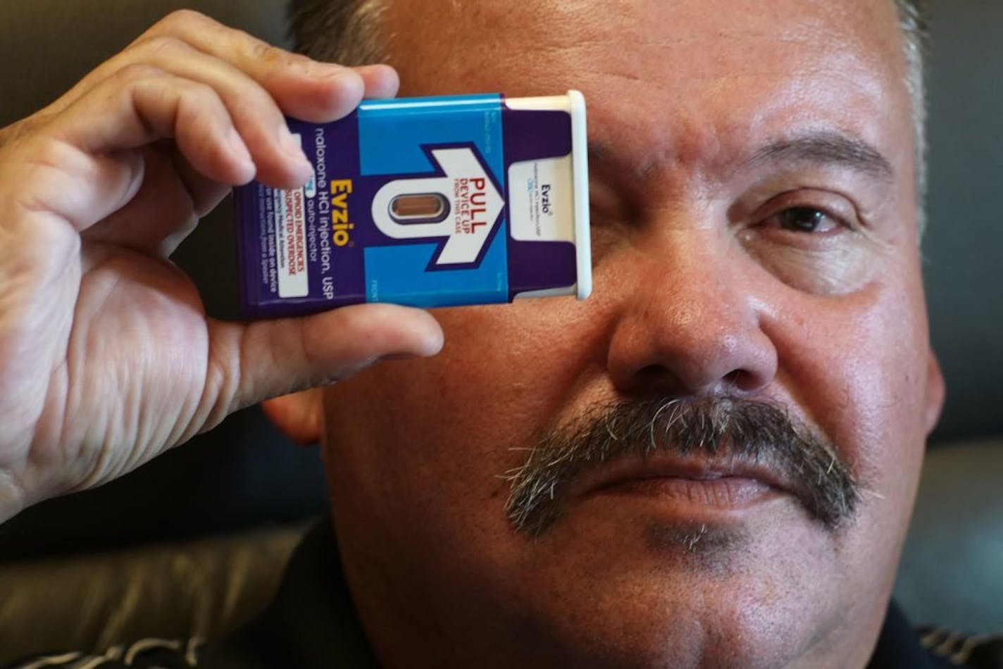 Public Safety Director William Brunelle holds up a naloxone injector which costs $2000, up from $400 since it was reformulated. The department depends on grant money for the lifesaving drug.