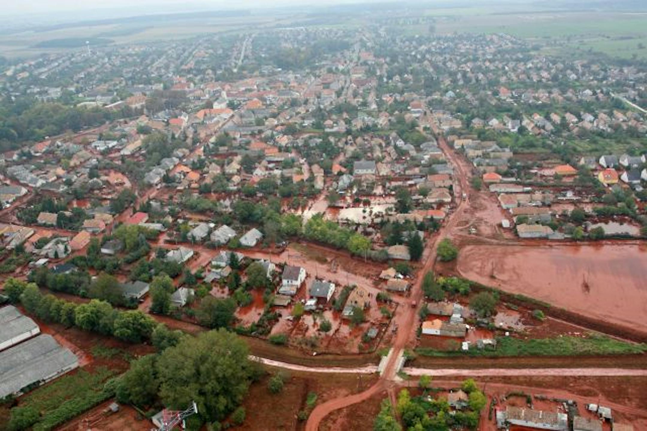 An aerial view shows red sludge that escaped from a factory's waste reservoir and covered neighborhoods of Kolontar in southwestern Hungary. The sludge is a byproduct of making alumina, the basic material in aluminum. It is extremely alkaline, making it a caustic agent.