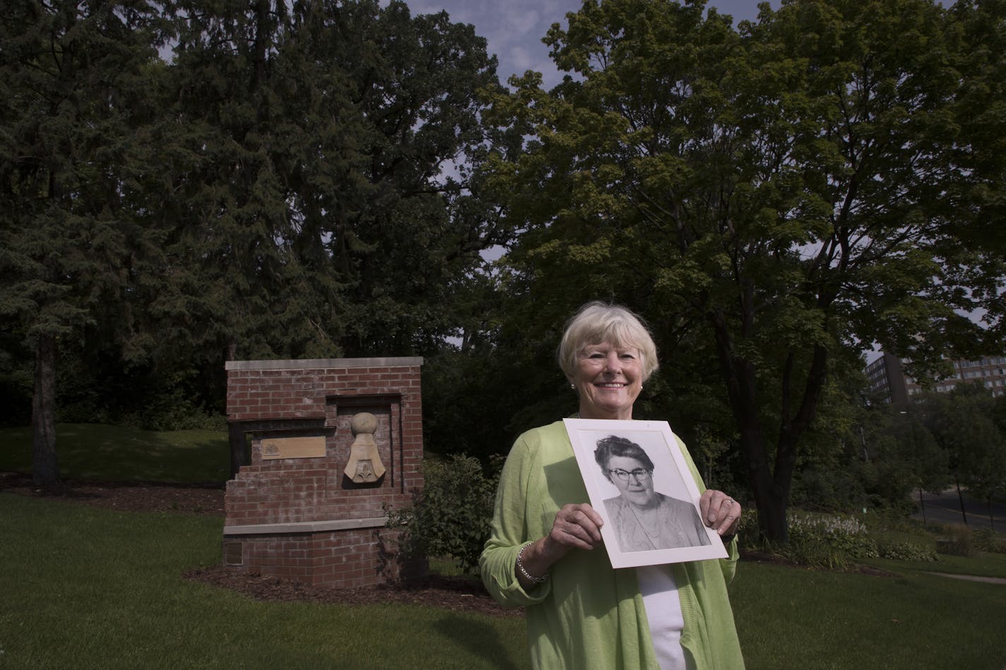 Susan Grannis O&#x2019;Brien holds a photo of her grandmother Macha Grannis, a women's right advocate and the first woman in South St. Paul, the state and the country to vote after the 19th Amendment took effect.