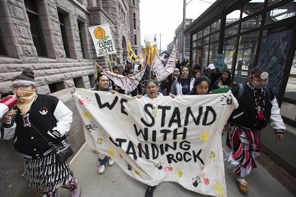 Activists marched outside Minneapolis City Hall on Oct. 25 protesting the use of Hennepin County Sheriff's deputies at the North Dakota pipeline site.
