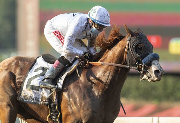 In a photo provided by Benoit Photo, Improbable and jockey Drayden Van Dyke win the Grade I, $300,000 Awesome Again Stakes horse race Saturday, Sept. 