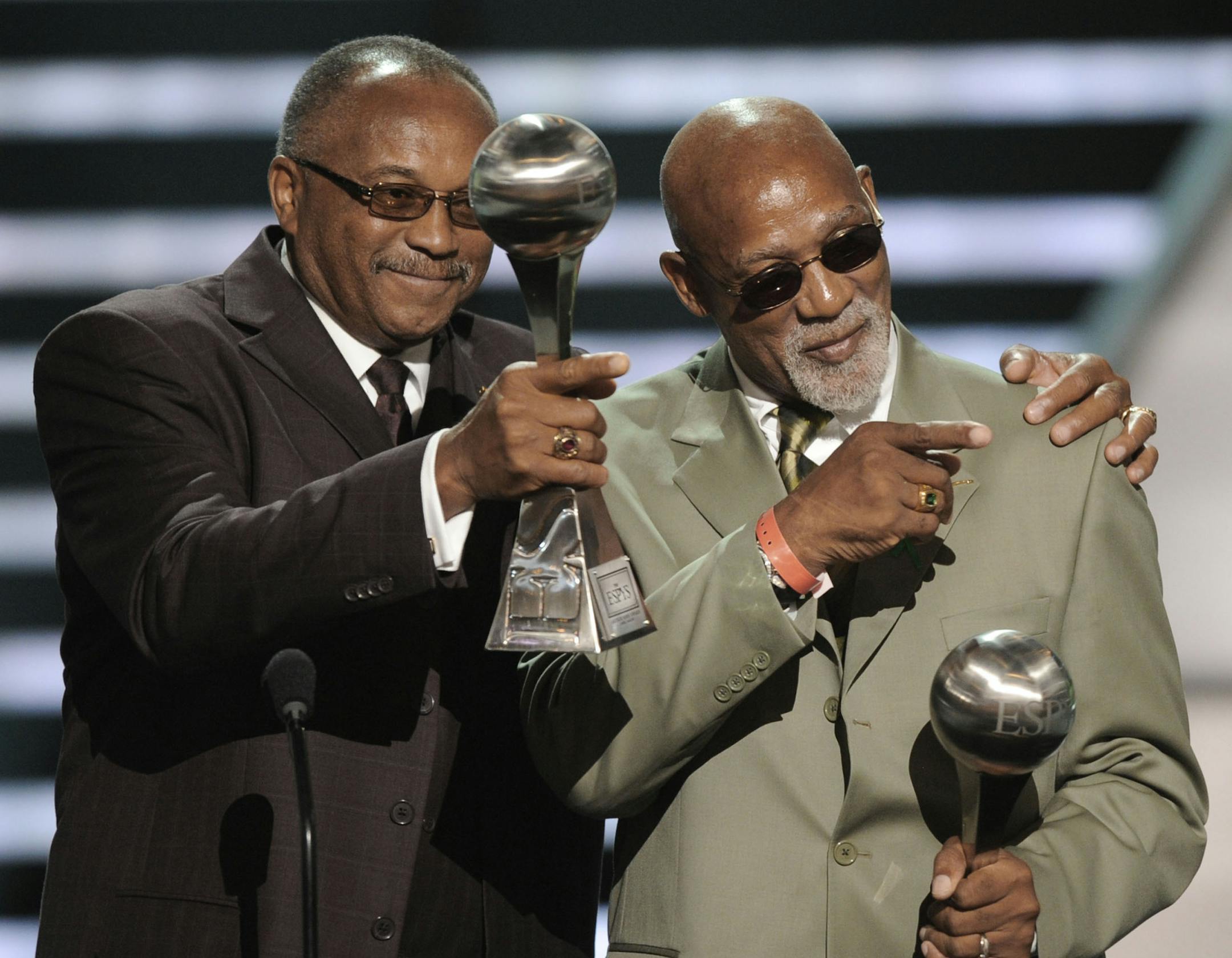 File-This July 16, 2008, file photo shows Tommie Smith, left, and John Carlos accepting the Arthur Ashe Award for Courage at the ESPYs Awards in Los Angeles. Smith and Carlos, the American sprinters whose raised-fist salutes at the 1968 Olympics are an ageless sign of race-inspired protest, will join the U.S. Olympic team at the White House next week for its meeting with President Barack Obama. (AP Photo/Kevork Djansezian, File)