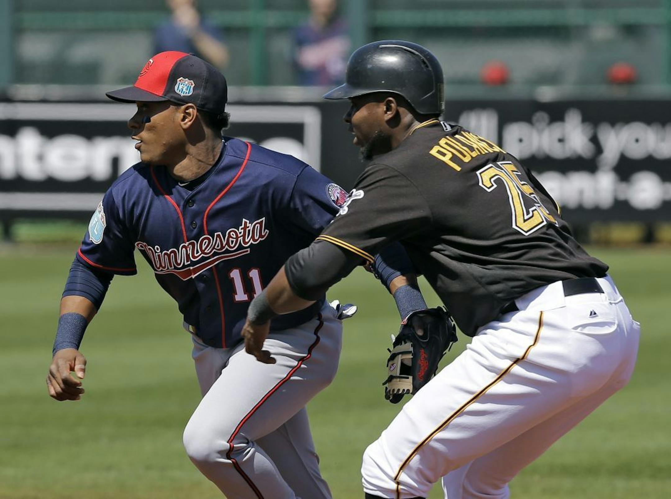 Minnesota Twins shortstop Jorge Polanco (11) tags out Pittsburgh Pirates' Gregory Polanco (25) after he was caught in a rundown during the first inning of a spring training baseball game Friday, March 4, 2016, in Bradenton, Fla.