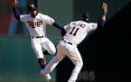 Byron Buxton, left, and Jorge Polanco celebrated the Twins' 6-4 victory over the Tigers on Sunday. In the third inning, Buxton again slammed against t