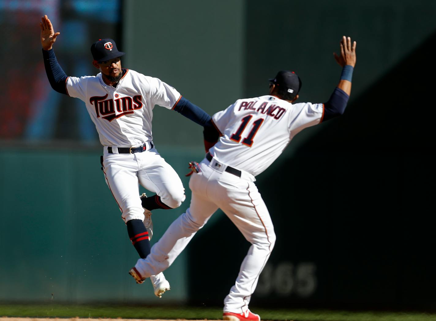 Byron Buxton, left, and Jorge Polanco celebrated the Twins' 6-4 victory over the Tigers on Sunday. In the third inning, Buxton again slammed against the center field wall to rob Detroit's Christin Stewart of an extra-base hit.