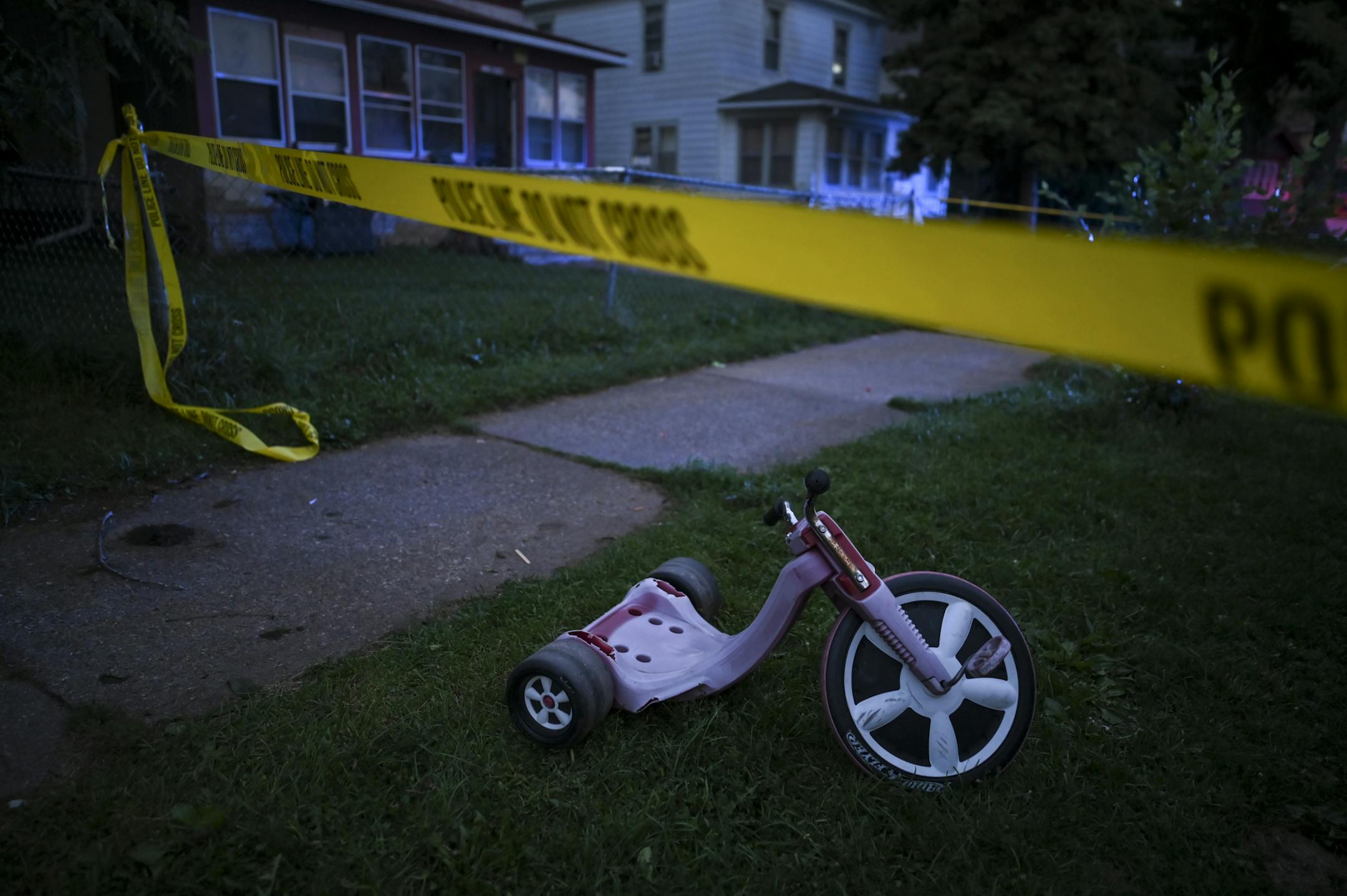 A child's tricycle inside the police tape at the scene of Friday night's shooting in north Minneapolis, in which multiple people were reported shot. ] aaron.lavinsky@startribune.com Minneapolis Police investigated a shooting, with multiple victims, on Friday, Aug. 28, 2020 near North 24th Avenue and Irving in Minneapolis, Minn.