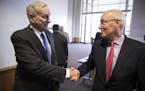 Minnesota Management and Budget commissioner Myron Frans, right, shakes hands with Governor Mark Dayton after the Minnesota Budget and Economic Foreca