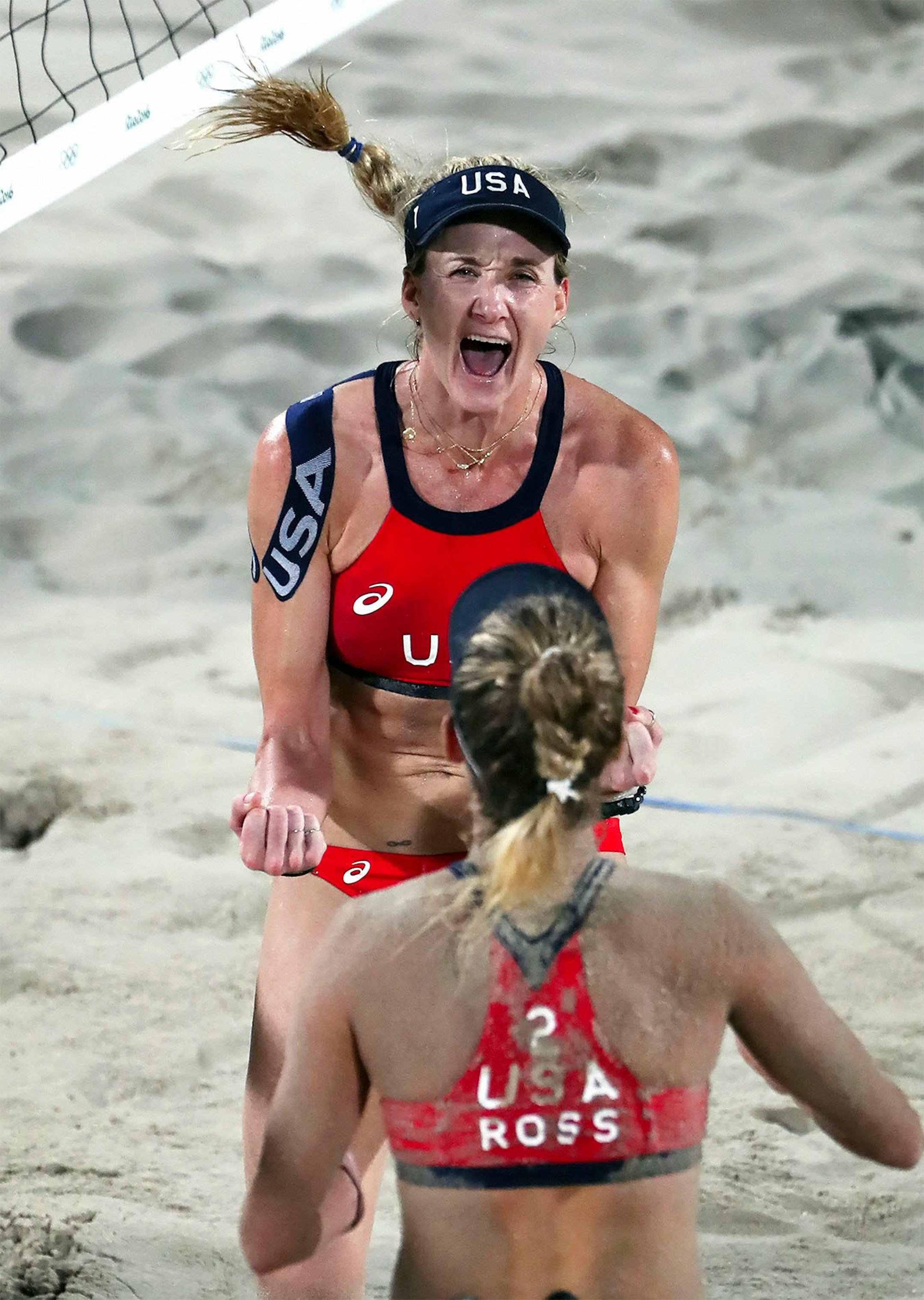 USA's Kerri Walsh Jennings (top) and April Ross celebrate their victory in the bronze medal match against Larissa Franca Maestrini and Talita Rocha from Brazil.