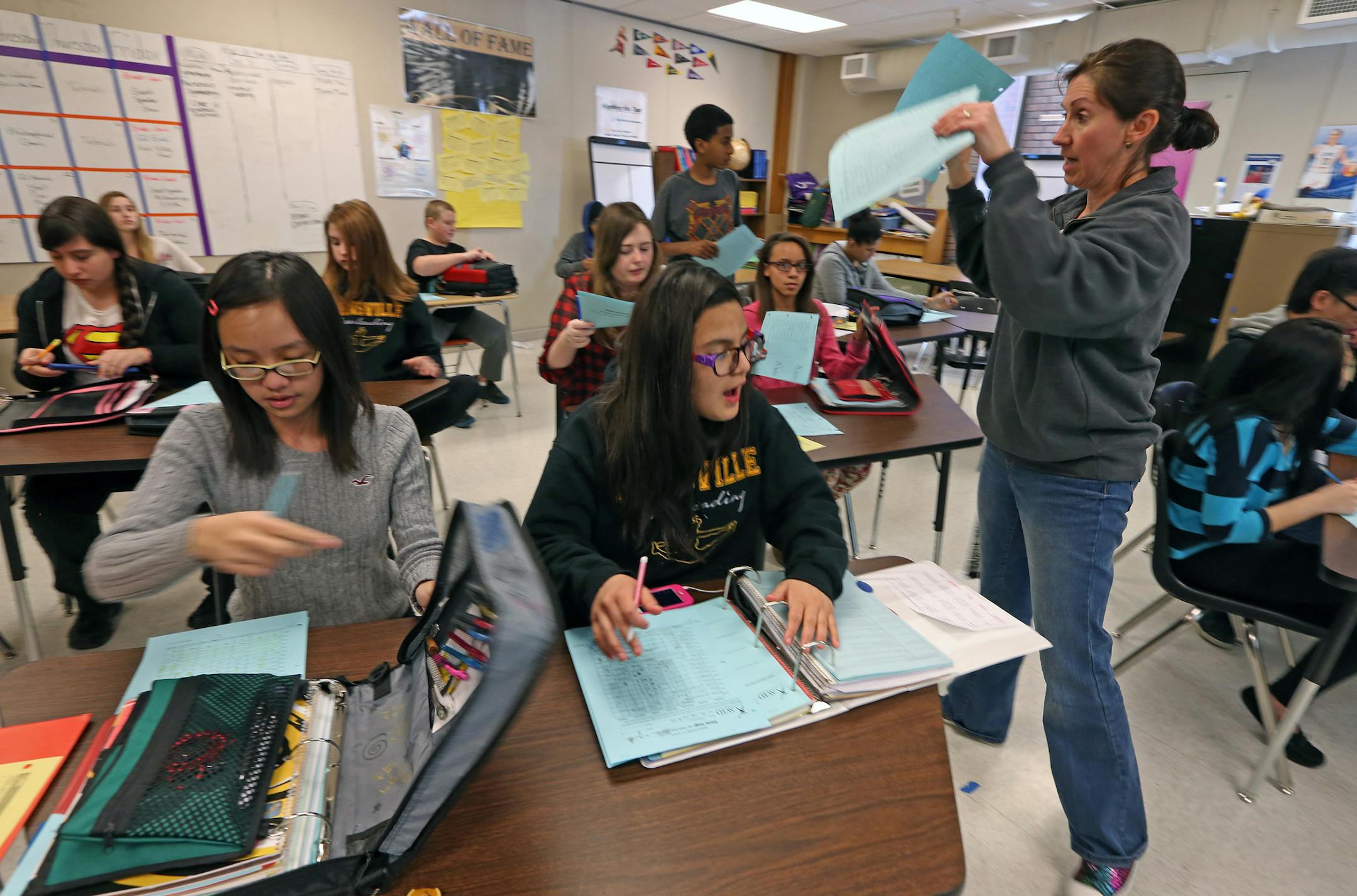 (left to right) Catlynn Dang and Donna Garzon packed up their folders, as teacher Amy Olson gave out assignments at the end of her AVID (advancement via individual determination ) class at Nicollet Junior High School on 1/29/14. The Burnsville and Lakeville districts have recently created their third integration plan via their Multi-District Collaborative Council. The plans are designed to encourage students from each district to attend school in the other, balancing out demographics. Creation o