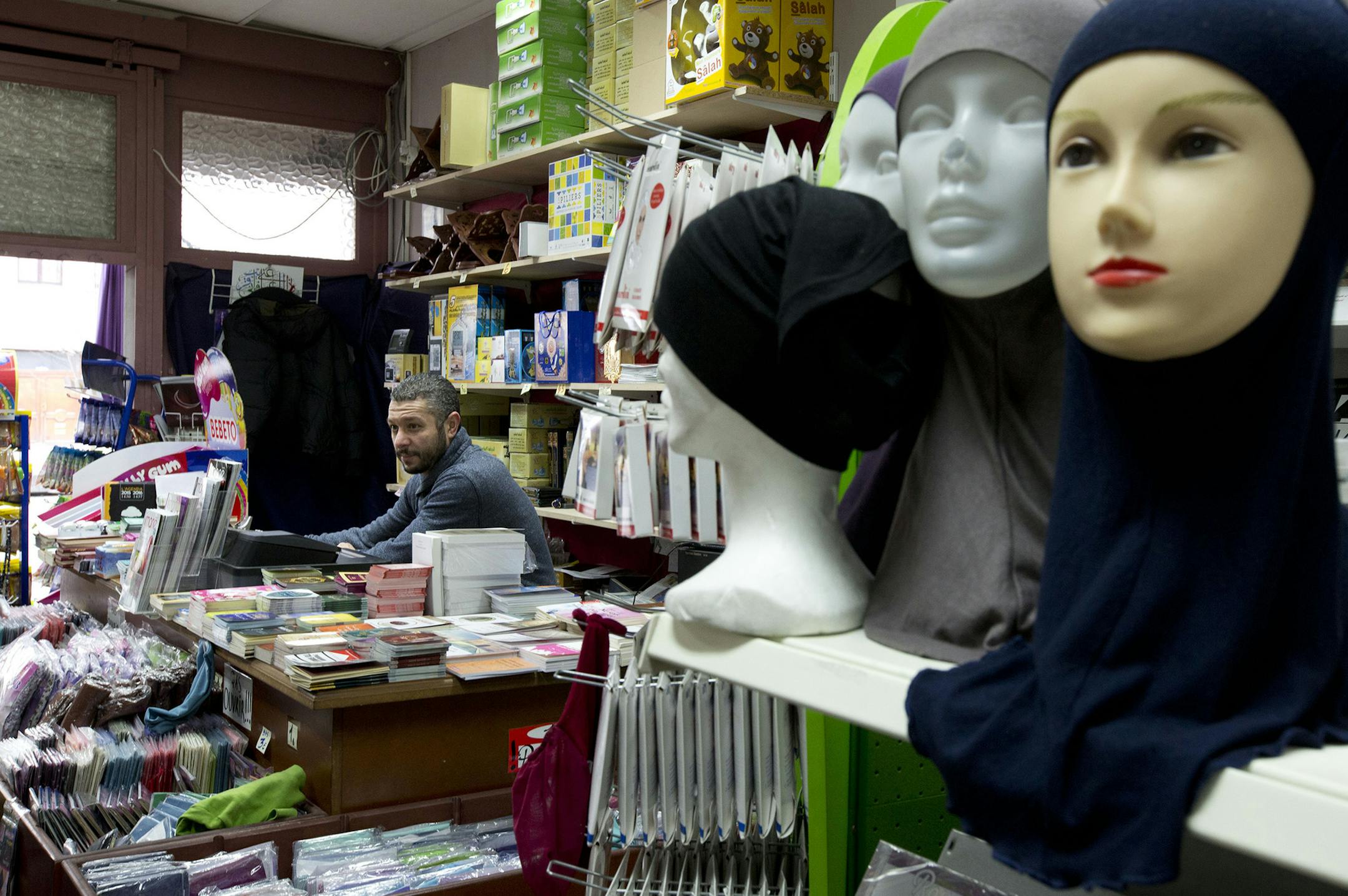 Pharred, the owner of Boutique Salam, answers questions of journalist in the Molenbeek neighborhood of Brussels, Belgium, Saturday, March 19, 2016, where fugitive Salah Abdeslam was arrested after a four-month manhunt. Abdeslam, the top suspect in last year's deadly Paris attacks, and a suspected accomplice have been discharged from a hospital in Brussels and will now face official questioning and a fast-track extradition effort. Abdeslam and his companion were injured when they were captured by