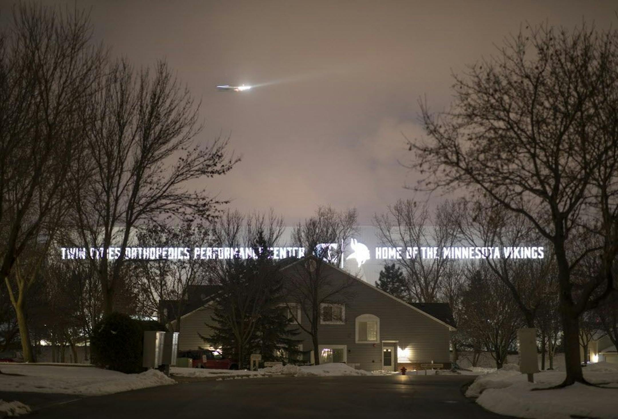 The lights from the signage on the side of the new Vikings practice facility in Eagan illuminate the homes on Lockwood Dr. in Mendota Heights.