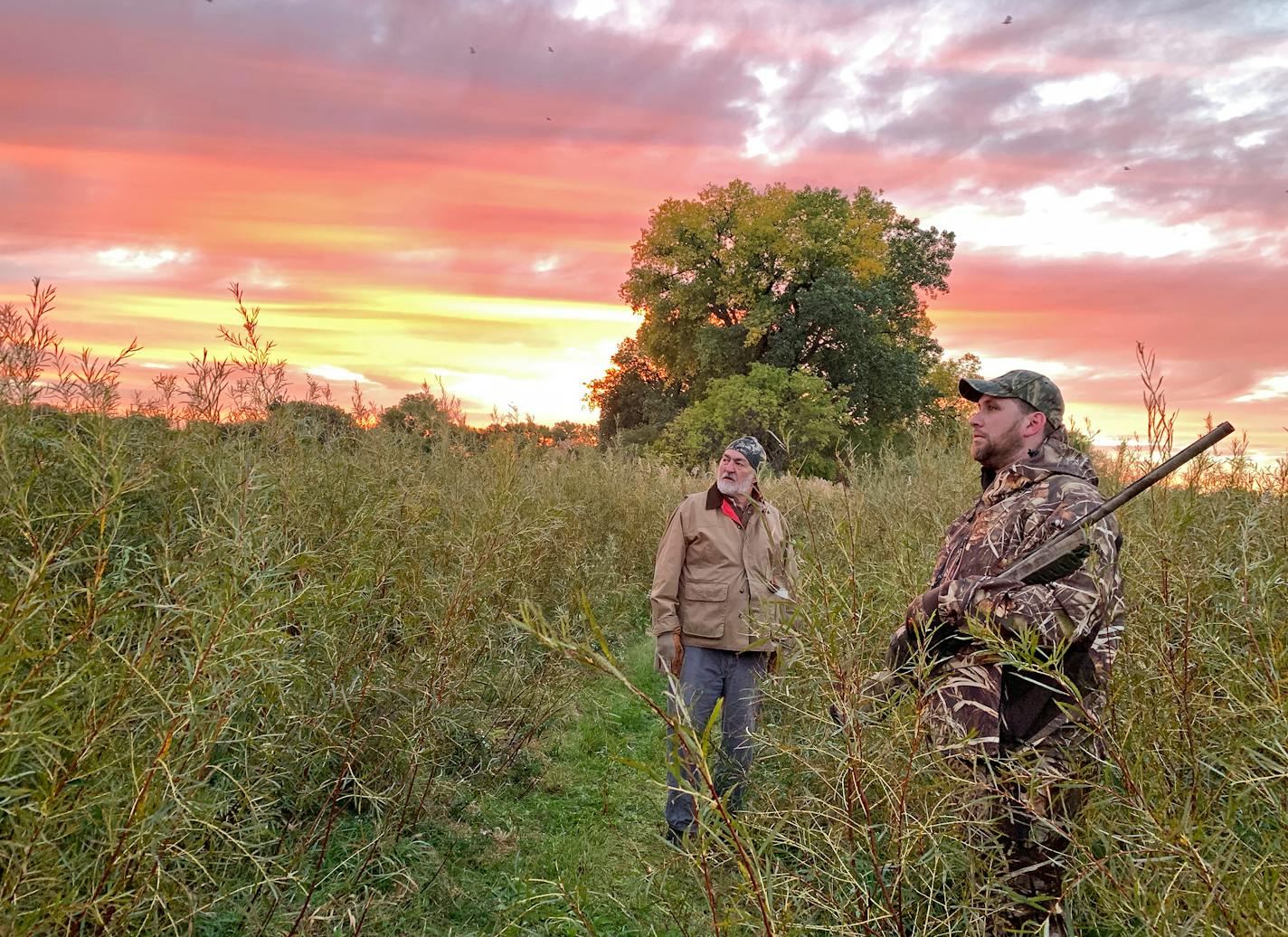 Tom Larson, left, and Matt Slater await a flight of ducks while hunting northwest of Willmar on Saturday, opening day of tbe 2021 Minnesota watrerfowl season.