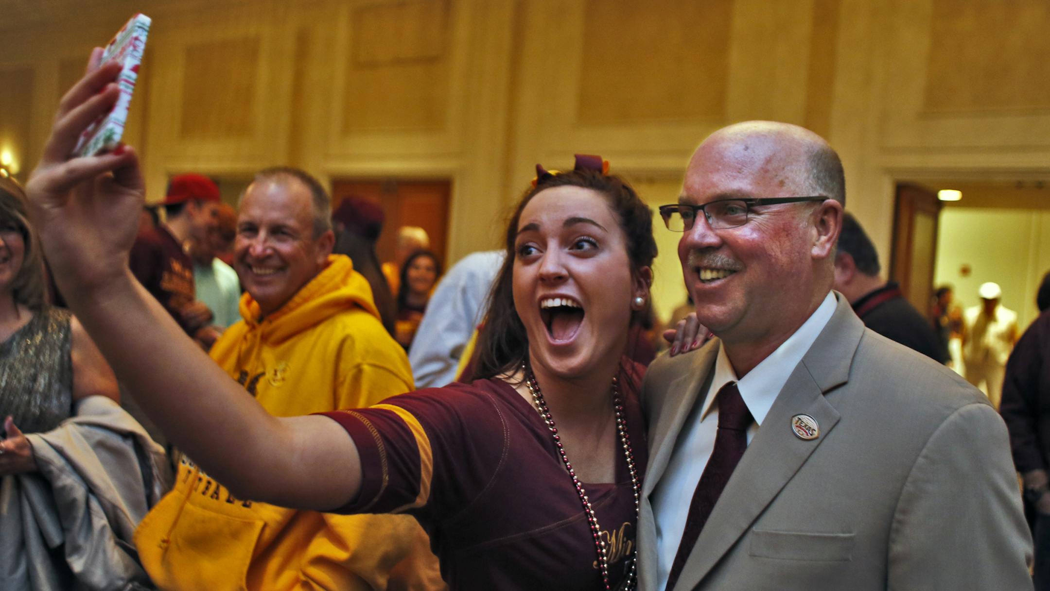Minnesota head football coach Jerry Kill and fans attended a pep rally at a Houston hotel. UM student Mattie Tietz from New Prague captured a "selfie" on her cell phone with coach Kill. (MARLIN LEVISON/STARTRIBUNE(mlevison@startribune.com)