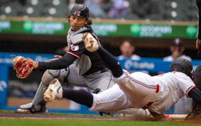 The Twins' Kody Clemens slides safely into home Wednesday ahead of a tag from Guardians catcher Bo Naylor. Clemens tripled in the fourth and scored on