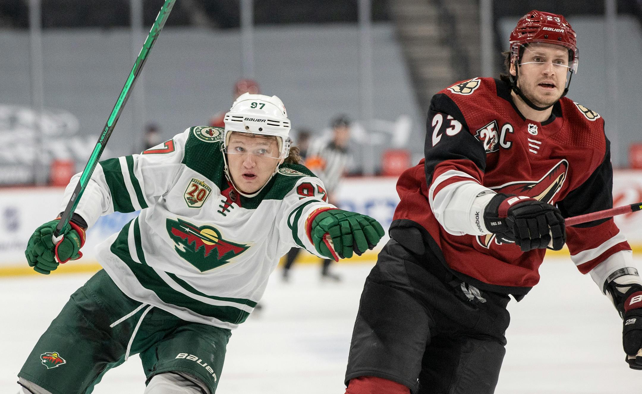 Kirill Kaprizov (97) of the Minnesota Wild and Oliver Ekman Larsson (23) of the Arizona Coyotes chased the puck in the first period.