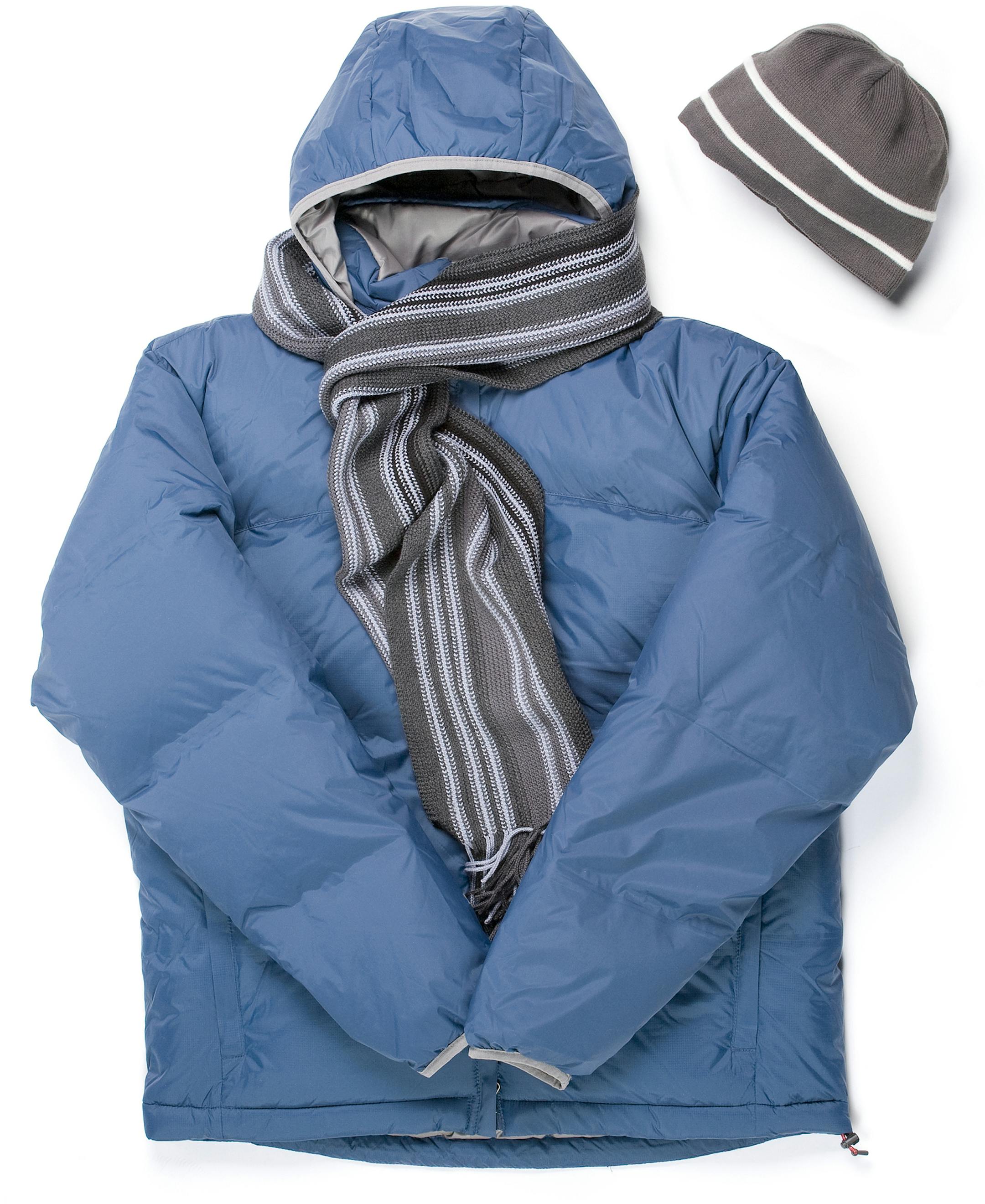 A blue winter parka, scarf and cap isolated on white. istock