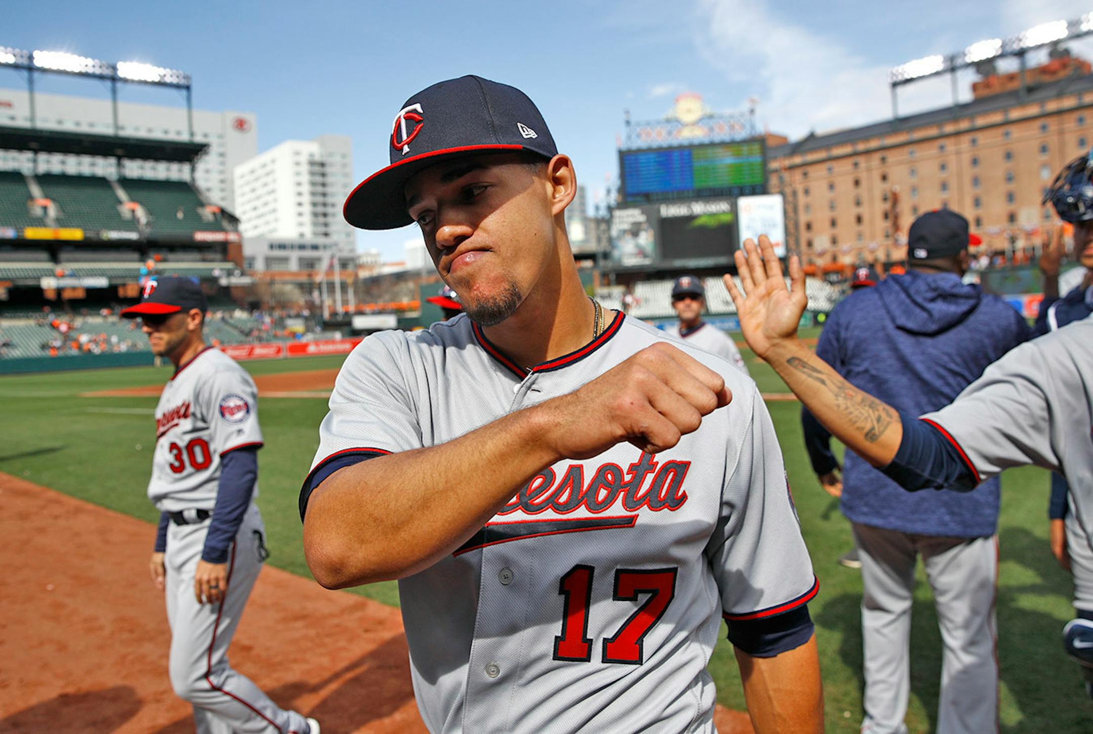 Minnesota Twins starting pitcher Jose Berrios gestures as he walks off the field with teammates after closing out a baseball game against the Baltimore Orioles, Sunday, April 1, 2018, in Baltimore. Berrios pitched a complete game and Minnesota won 7-0.