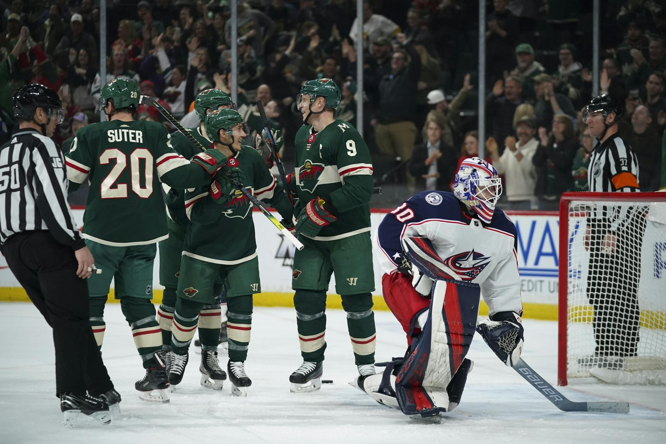 teammates congratulated Minnesota Wild center Mikko Koivu (9) on his second goal of the game, late in the second period.