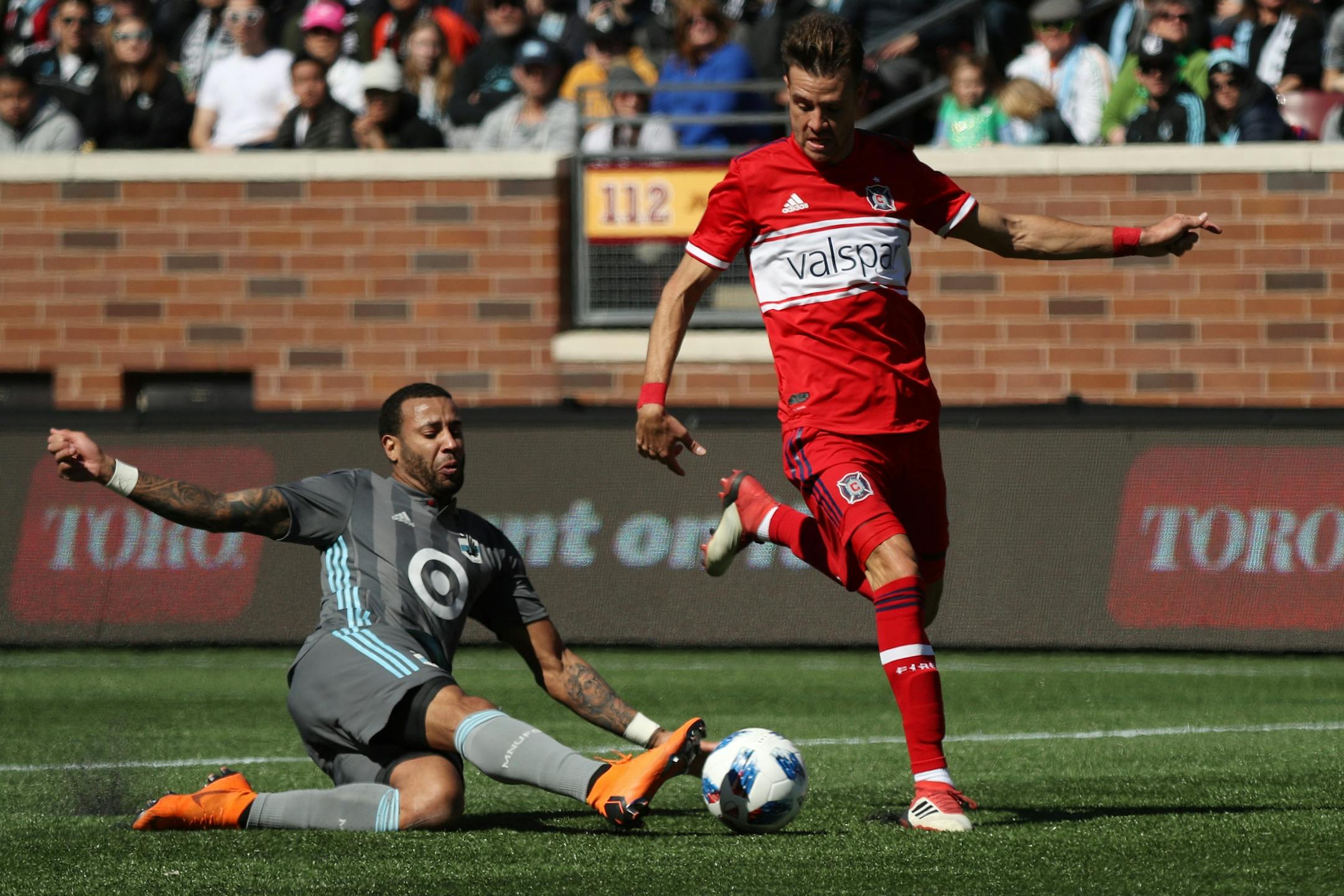 Minnesota United defender Tyrone Mears (4) dove to clear the ball as Chicago Fire forward Luis Solignac (9) went in for a shot on Minnesota United goalkeeper Matt Lampson (28) in the first half.
