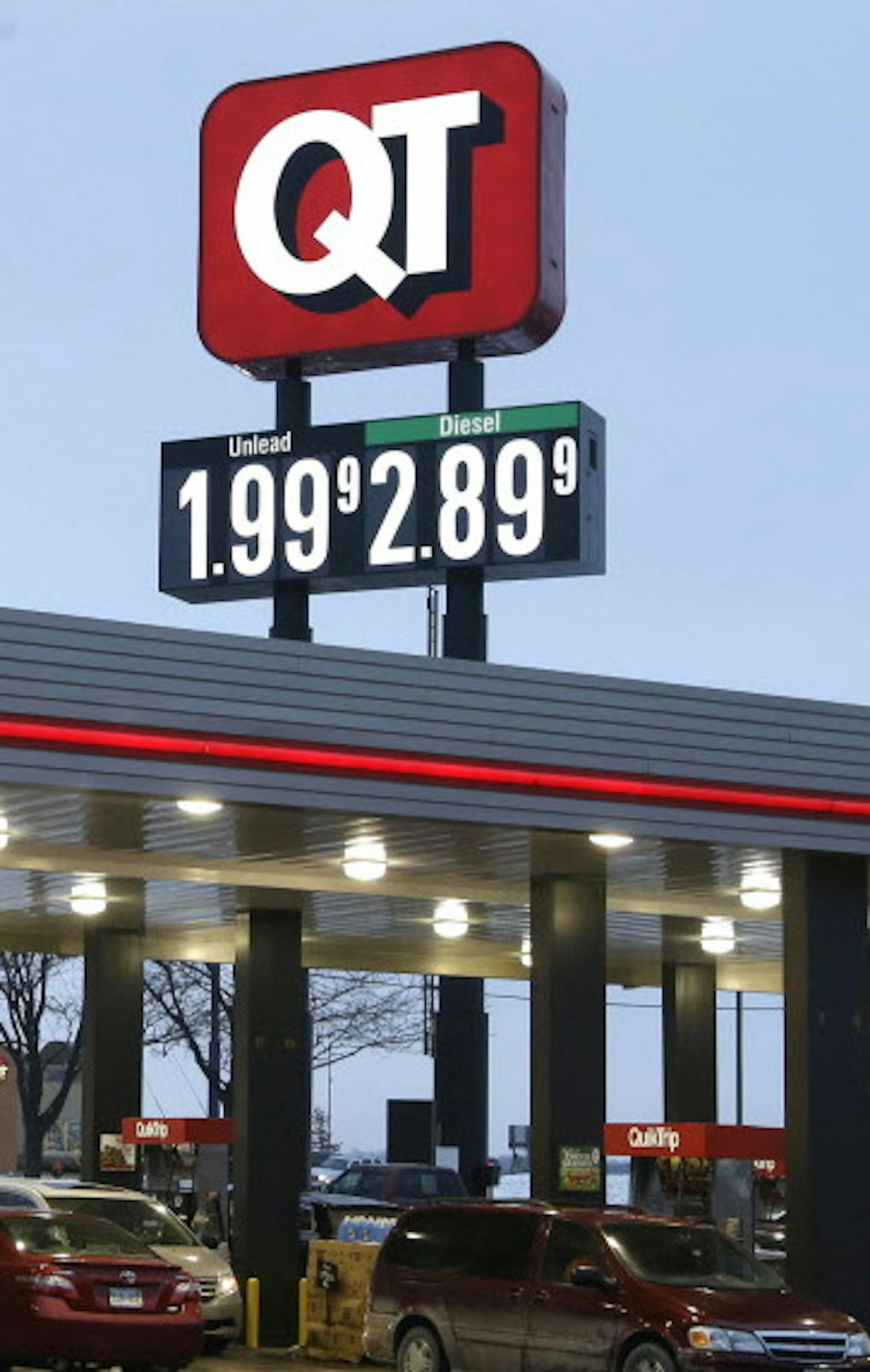 FILE - In this Friday, Dec. 19, 2014 file photo, motorists fill their tanks at a convenience store in Platt City, Mo., where prices dropped below $2-per-gallon for regular gas. In the second half of 2014, the price of oil dropped by half, to depths not seen since May of 2009 when the U.S. was in the Great Recession. By December, some drivers even saw a price at the pump that started with a $1. (AP Photo/Orlin Wagner, File)