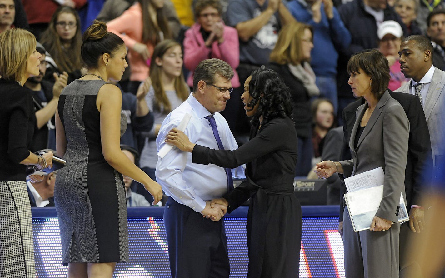 Connecticut coach Geno Auriemma and South Carolina coach Dawn Staley shake hands after a February 2015 game in Storrs, Conn.